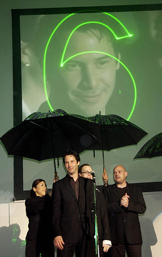 American actor Keanu Reeves, front, director Andy Wachowski, right, and Larry Wachowski, behind Reeves, wait during countdown six seconds till the opening of world premiere of Matrix Revolutions, at a Tokyo movie theater. The final episode of the trilogy was released in more than 60 cities worldwide simultaneously, November 5, 2003 at 11 P.M. in Japan.